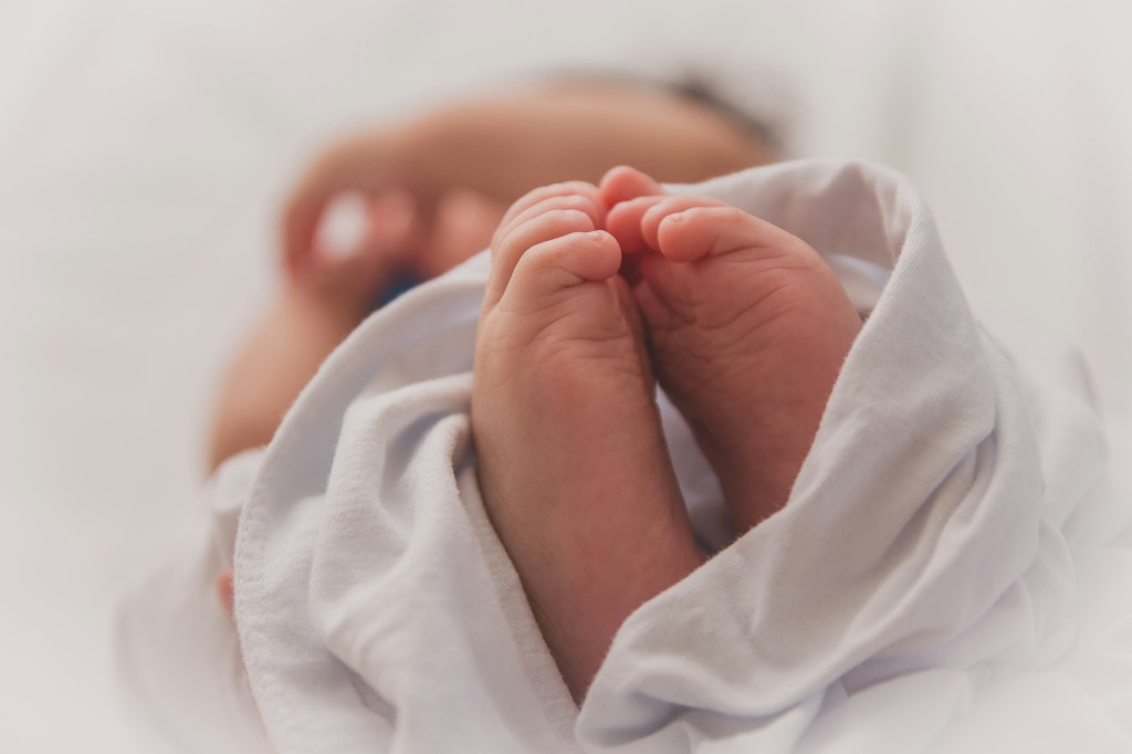 Close-up photo of a baby's feet poking out of a swaddle